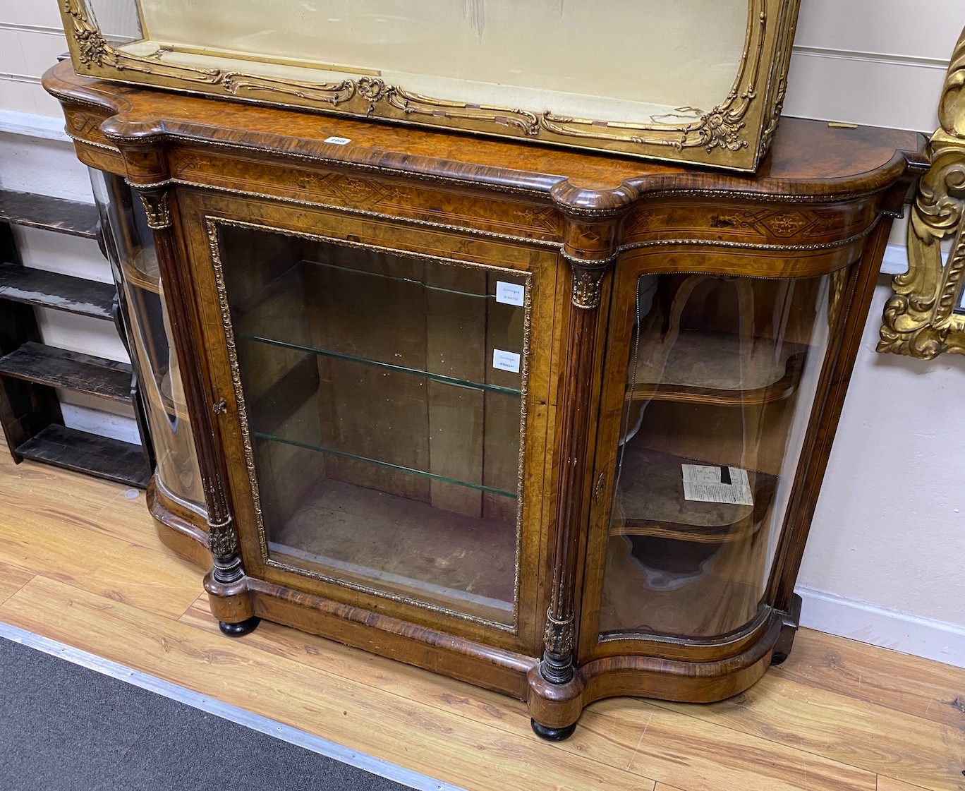 A Victorian gilt metal mounted burr walnut serpentine credenza, width 148cm, depth 44cm, height 105cm